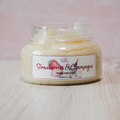 Jar of 'Strawberries & Champagne' foaming sugar scrub with a pink background